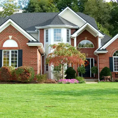 brick home with nice front lawn - lawn care service