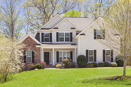 two story house with nice green healthy front lawn